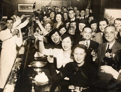 Prohibition-era celebration with crowd raising glasses - 1933 Liquor Co Bootlegger Club