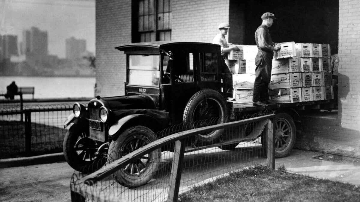 Prohibition-era bootlegger truck being loaded with crates - 1933 Liquor Co delivery